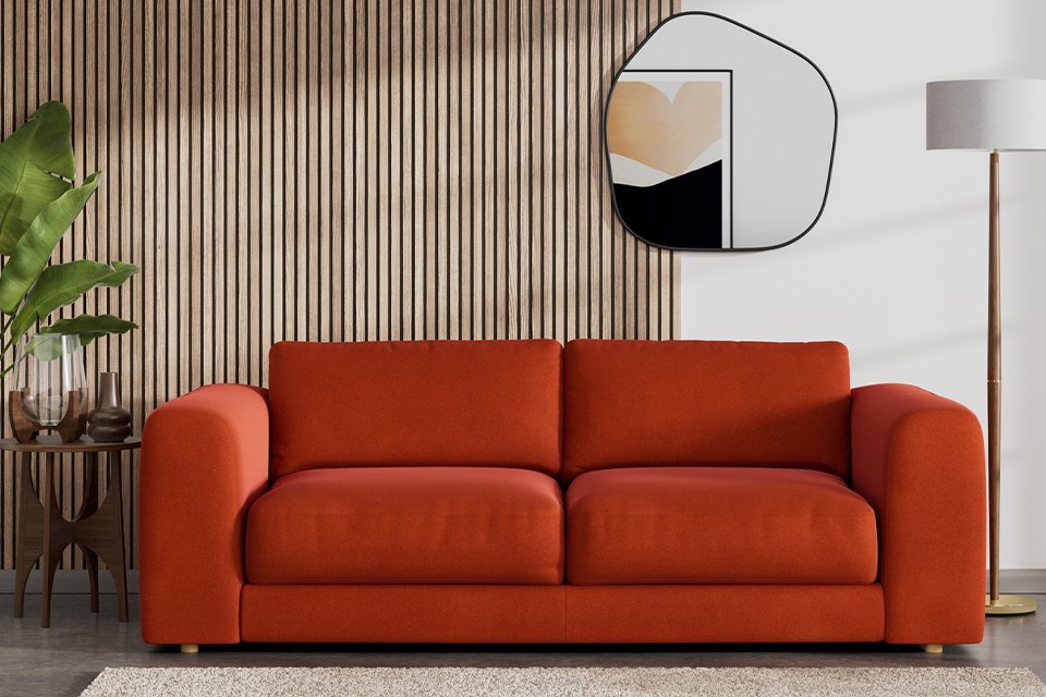 Red two seater fabric sofa.