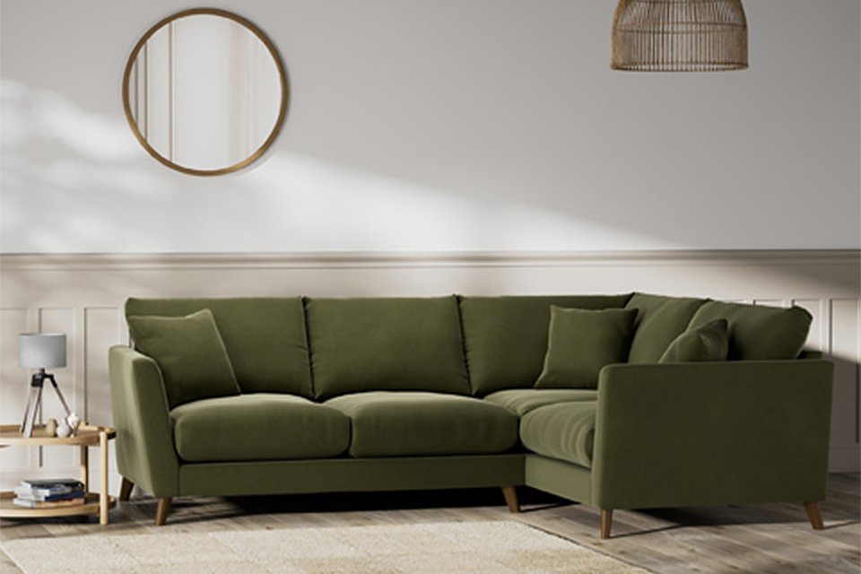 Green corner sofa in velvet.