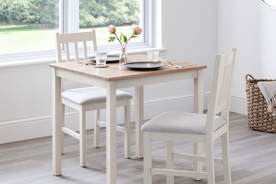 Julian Bowen Coxmoor oak dining table and 2 ivory chairs.