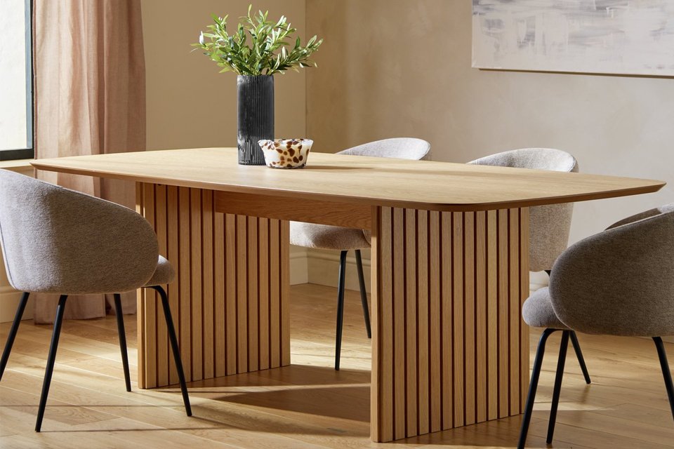 A wooden dining table with four chairs.