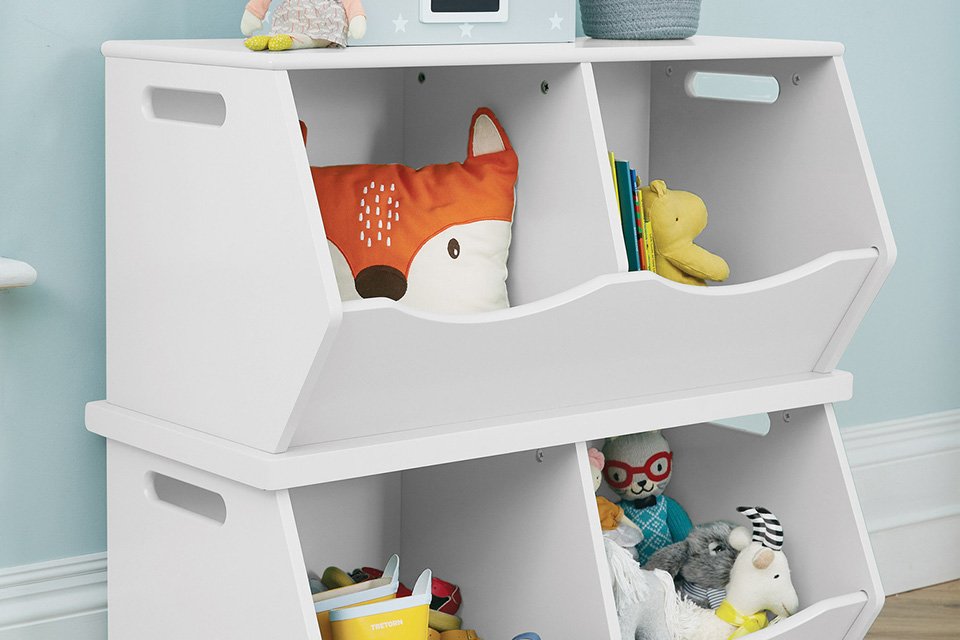 Small kids' items in a Great Little Trading Company double storage trunk in white. 