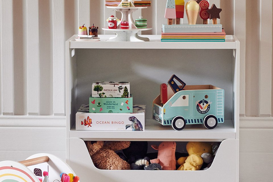 Toys stored in a white Great Little Trading Company Rackham storage chest. 