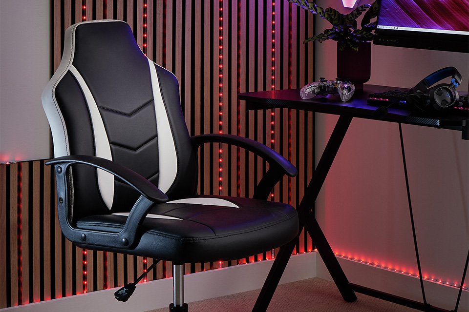 A gaming station with a white gaming chair.