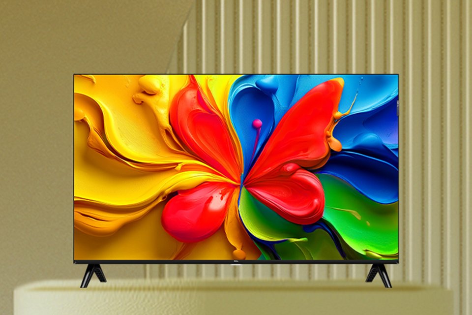 A colourful and abstract screensaver displayed on a TCL FHD TV against a light brown background.