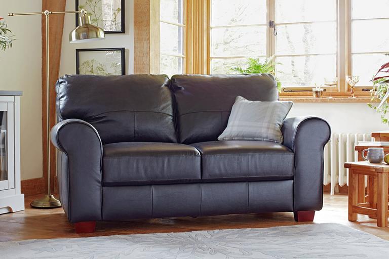 IMAGE ALT TEXT:  The black Habitat Salisbury 2-seater leather sofa in a country cottage style lounge