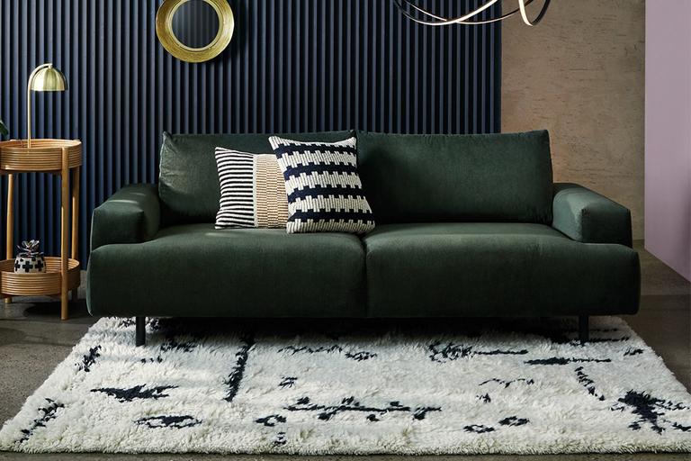The dark green Habitat Julien 3-seater fabric sofa in a glam lounge setting.