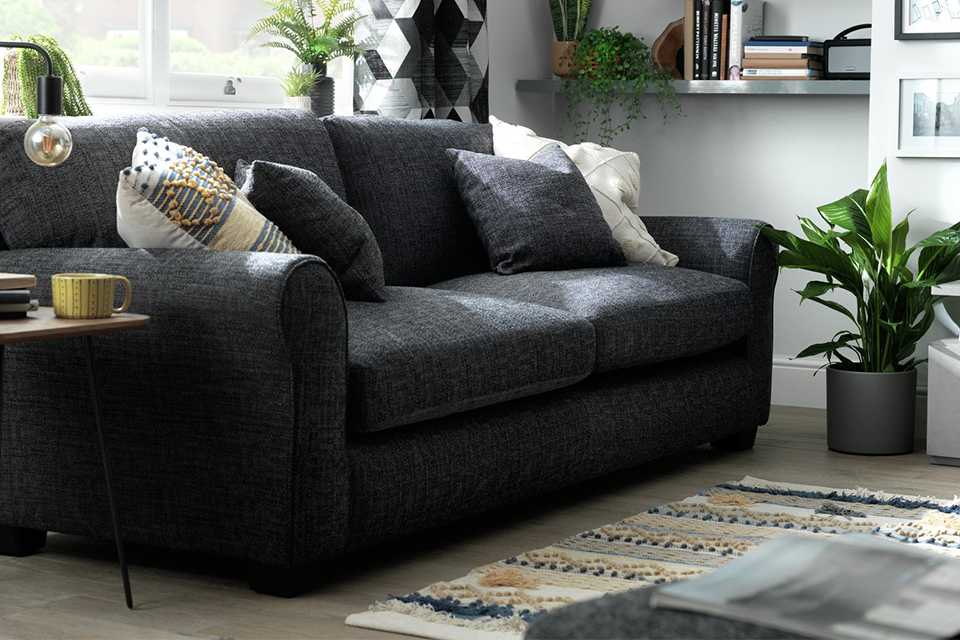 The charcoal Habitat Lisbon 4-seater fabric sofa in a smart lounge setting.