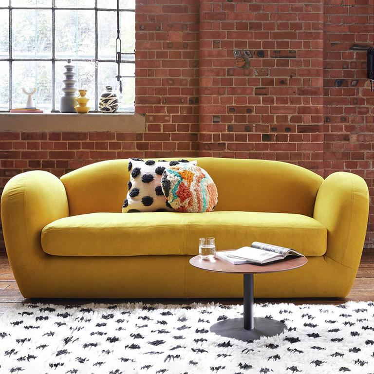 The yellow Habitat Layla 4-seater velvet sofa in an industrial-style lounge.