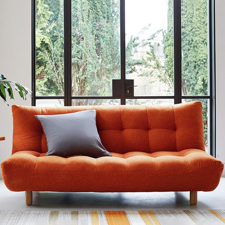 The orange Habitat Kota 3-seater fabric sofa bed with a large grey cushion on it.