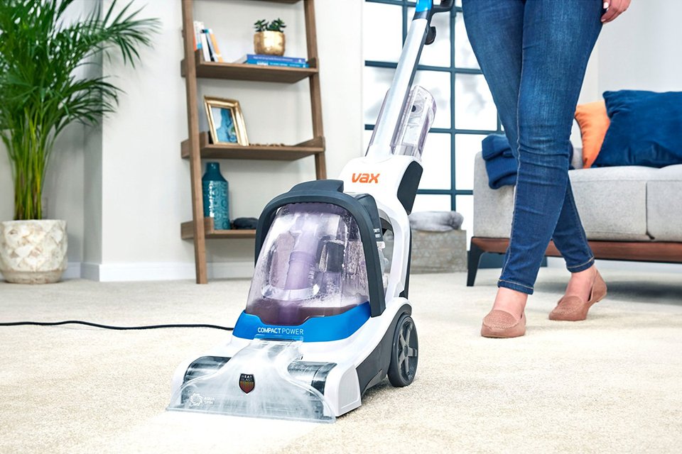 lifestyle shot of a person using a carpet cleaner