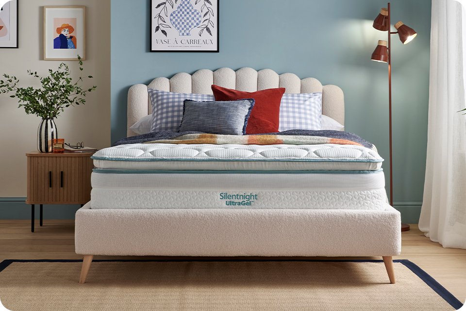 Silentnight mattress with pillows on a bed in a bedroom setup.