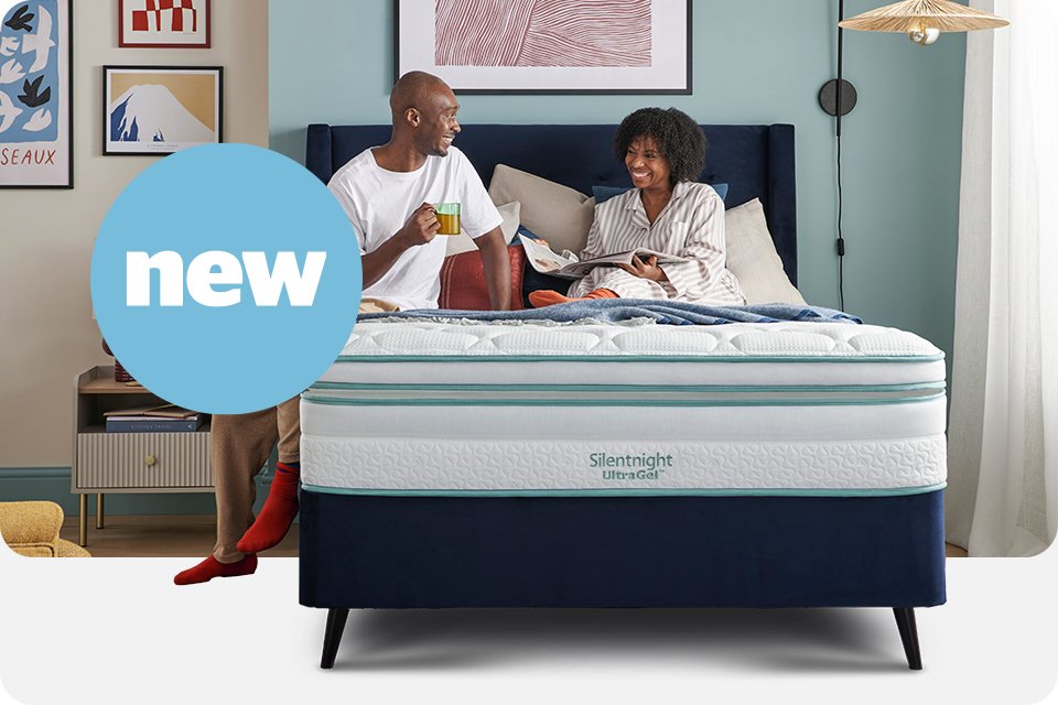A couple sitting on a Silentnight UltraGel™ mattress. 