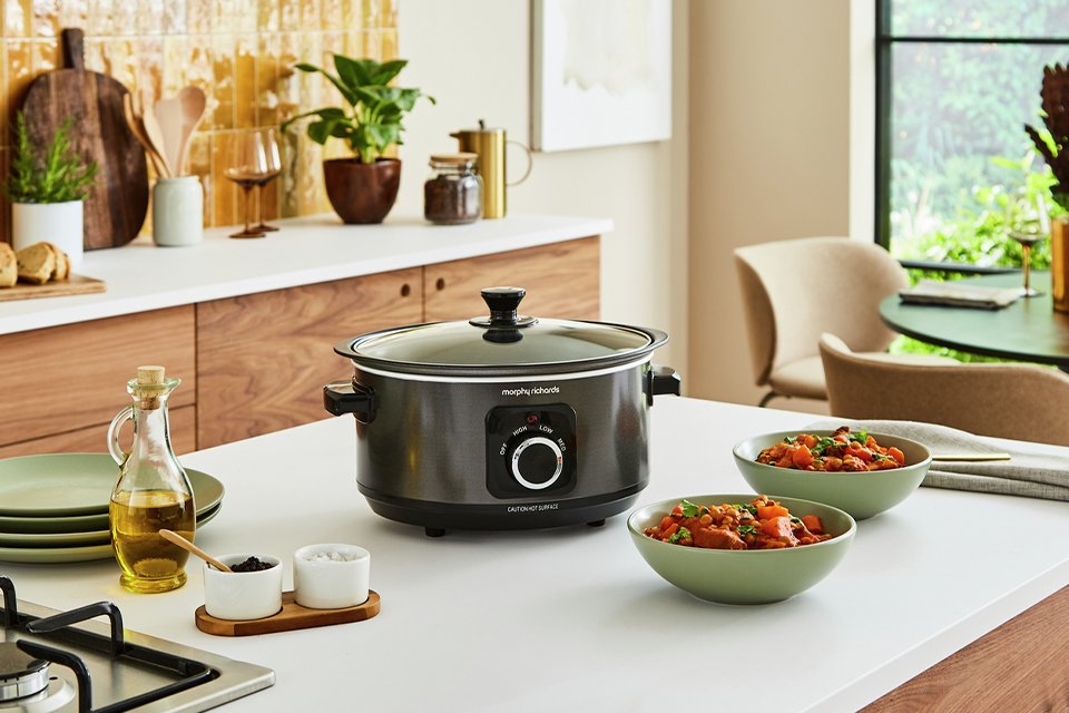 A slow cooker placed on a kitchen countertop.