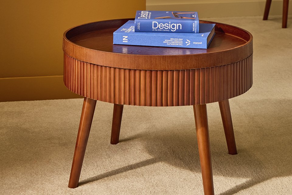 Blue coffee table books on a Habitat Agnes coffee table in walnut colour.