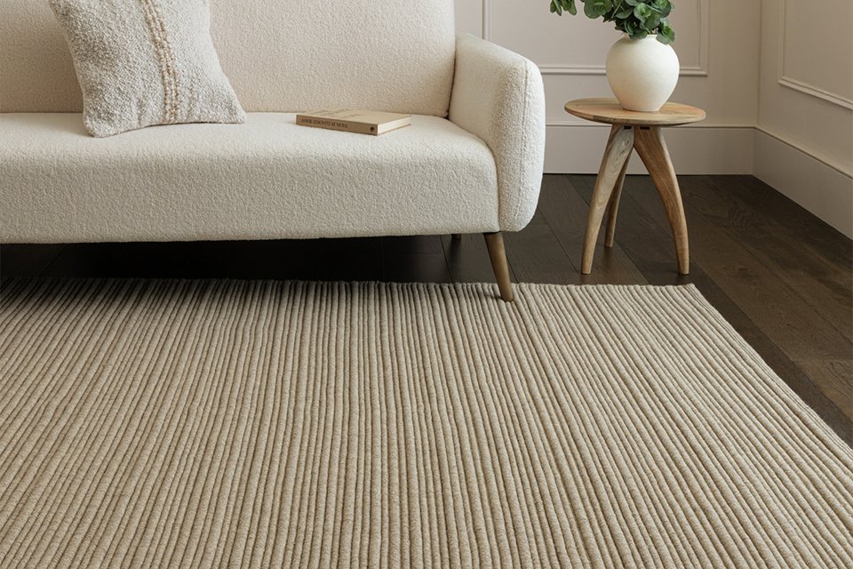 An Asiatic ravine sand wool flatweave rug in a living room.