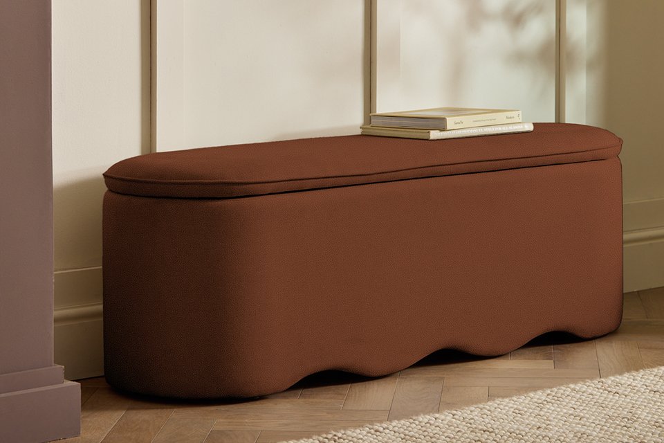 Books on a Habitat Onda Large Fabric Ottoman - Rust.