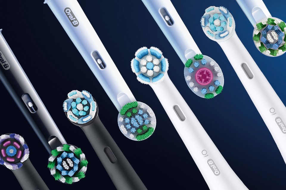 Various coloured Oral-B toothbrush heads displayed next to each other.