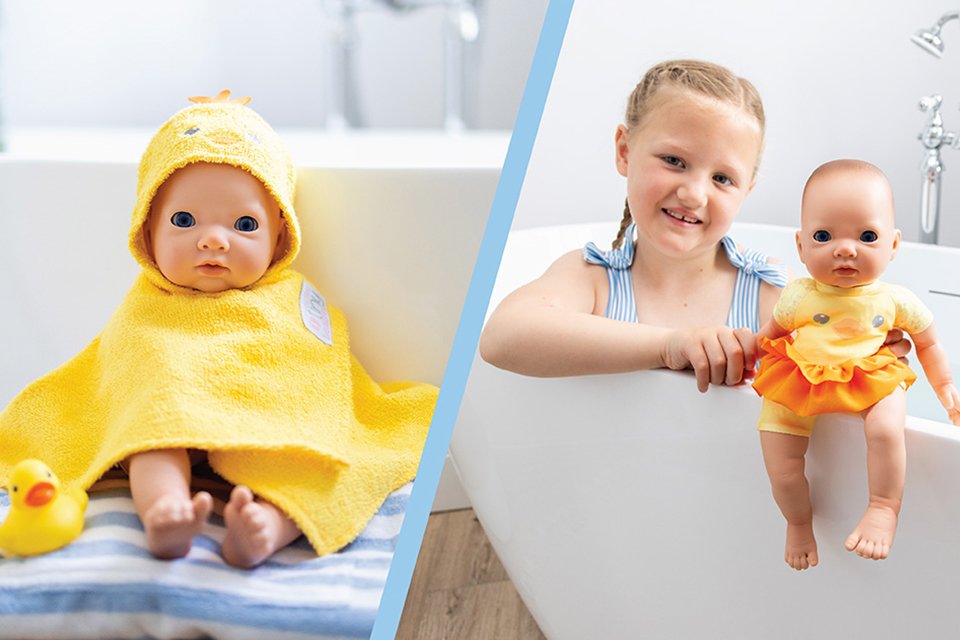 Little girl posing with My First Tiny Treasures Splish Splash Bathtime Fun Doll in a bathtub. 