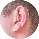A man with a hearing aid in his ear.