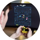 A man playing PAC-MAN Plug and Play Classic Retro game.