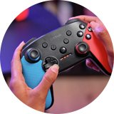 A person using Trust Muta Nintendo Switch 2 Wireless Controller in red and blue colour.