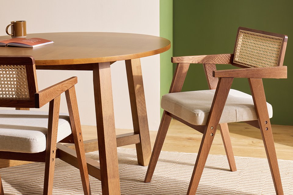 A Habitat cedric pair of solid wood dining chairs in walnut colour.