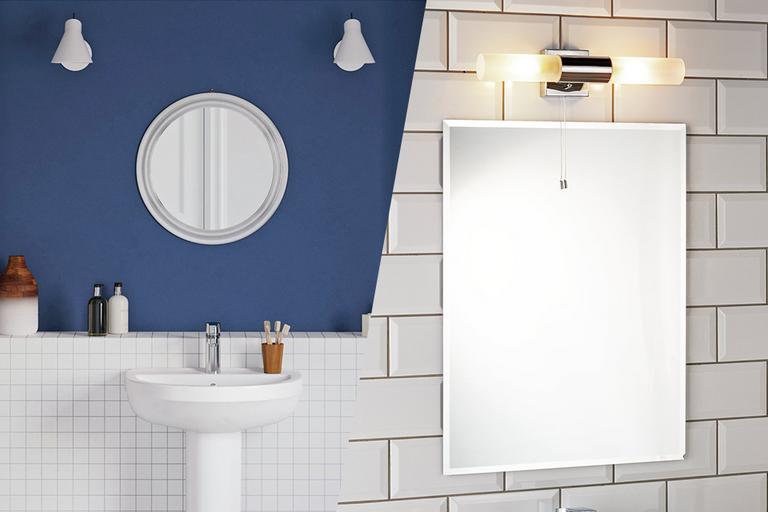 A blue and white tiled bathroom with large mirrors.