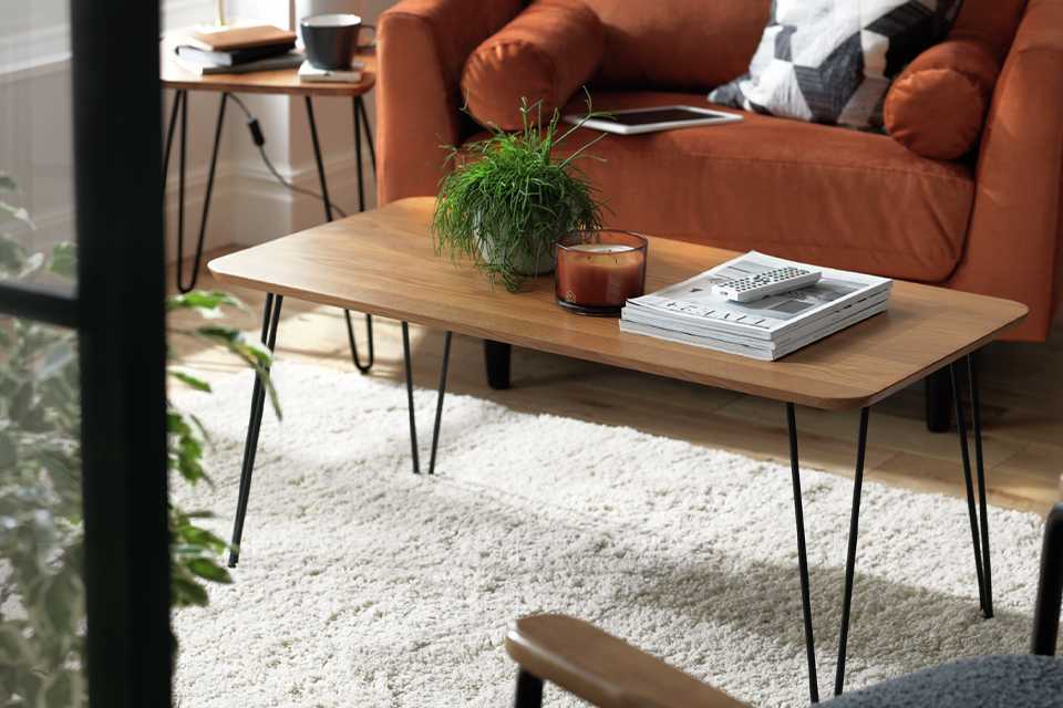 Image of scandi style, rectangular coffee table with wooden top and black hairpin legs.