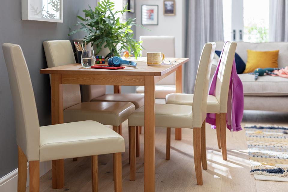 Solid wood dining set with cream upholstered chairs.