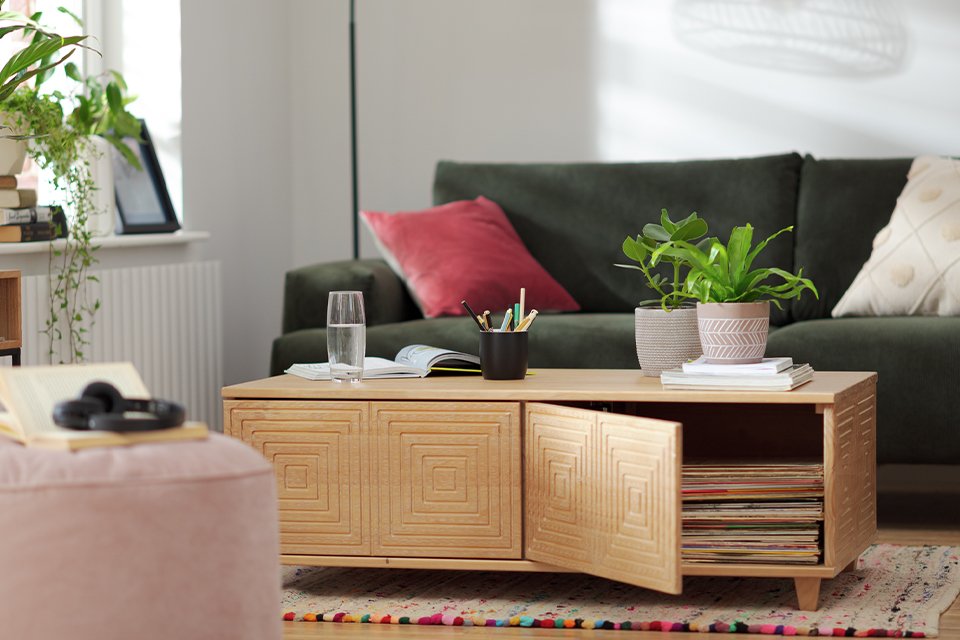 Wooden coffee table with storage in a living room setting.