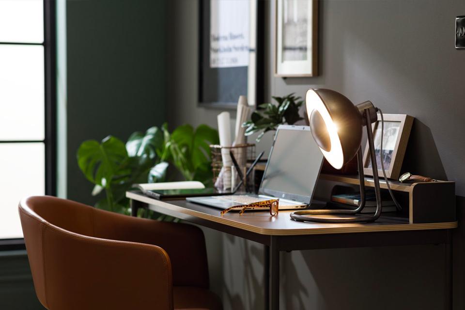 Image of a desk with a desk lamp.