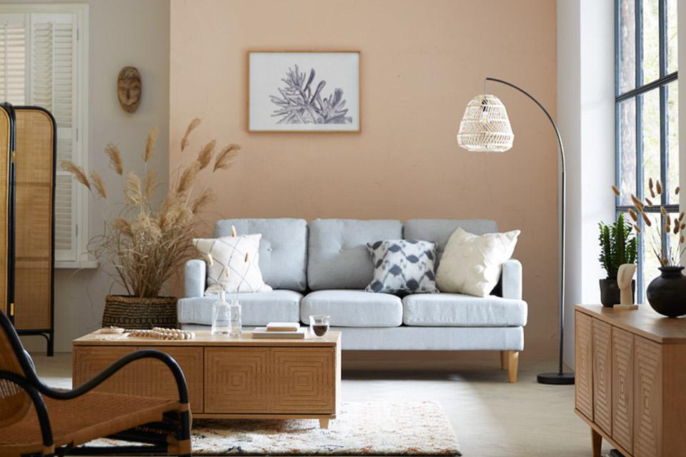Boho style lamp with grey sofa and curved floor standing lamp.