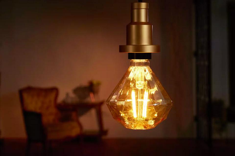 A vintage diamond shaped LED bulb in yellow. 
