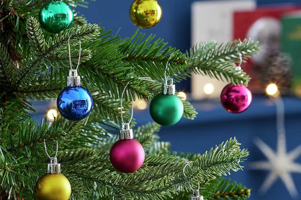 A Christmas tree with multicoloured baubles. 
