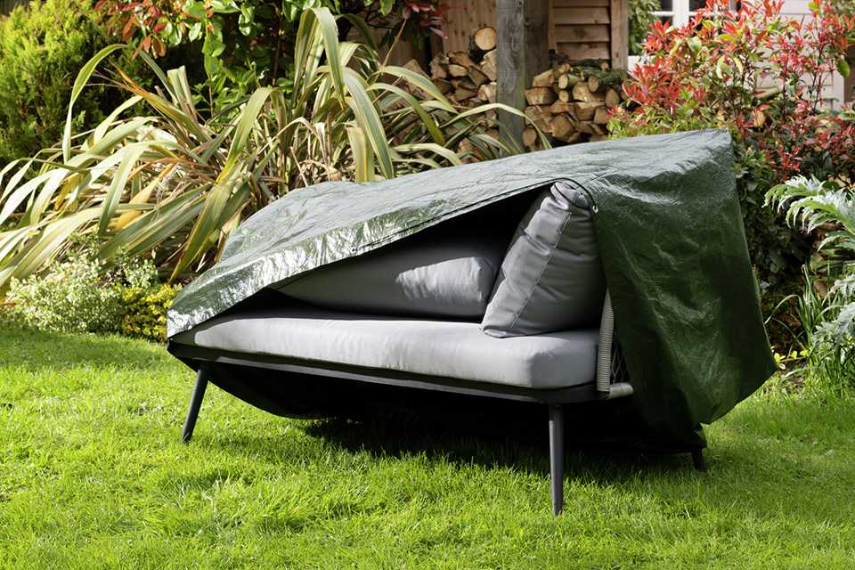 An Argos Home 2 seater sofa cover on a sofa in the garden.