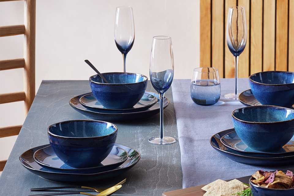Navy reactive 12pc tableware set on a dining room table.
