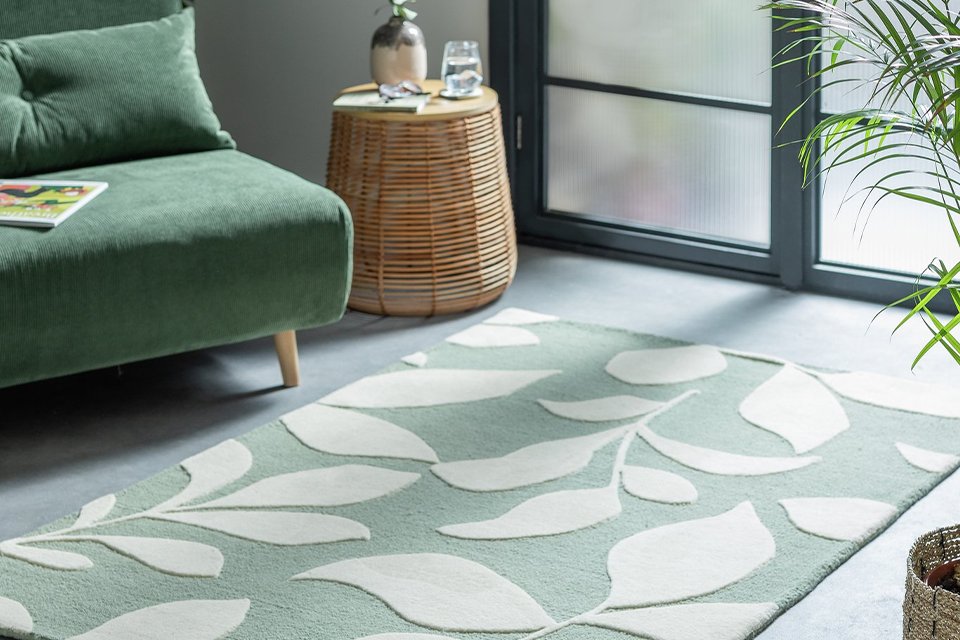 Green leaf rug on living room floor.