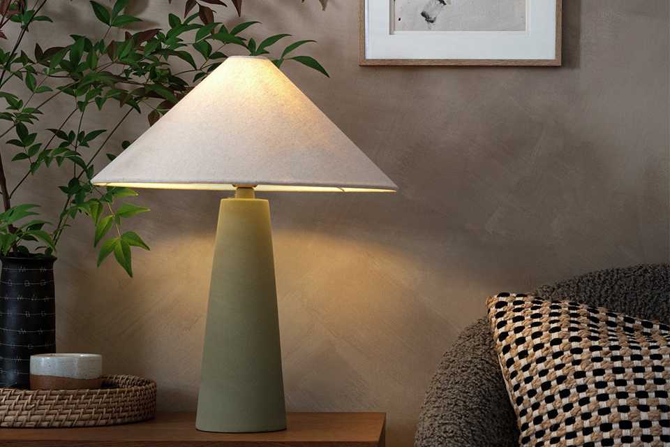 Lamp on wooden sideboard in living room.