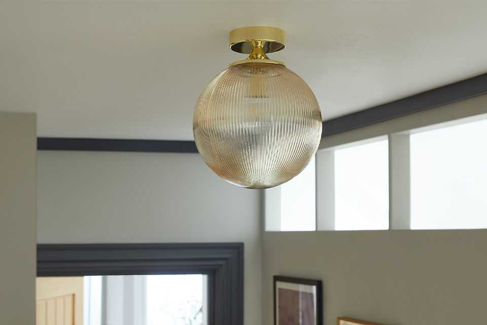 Bathroom round ceiling light in gold.