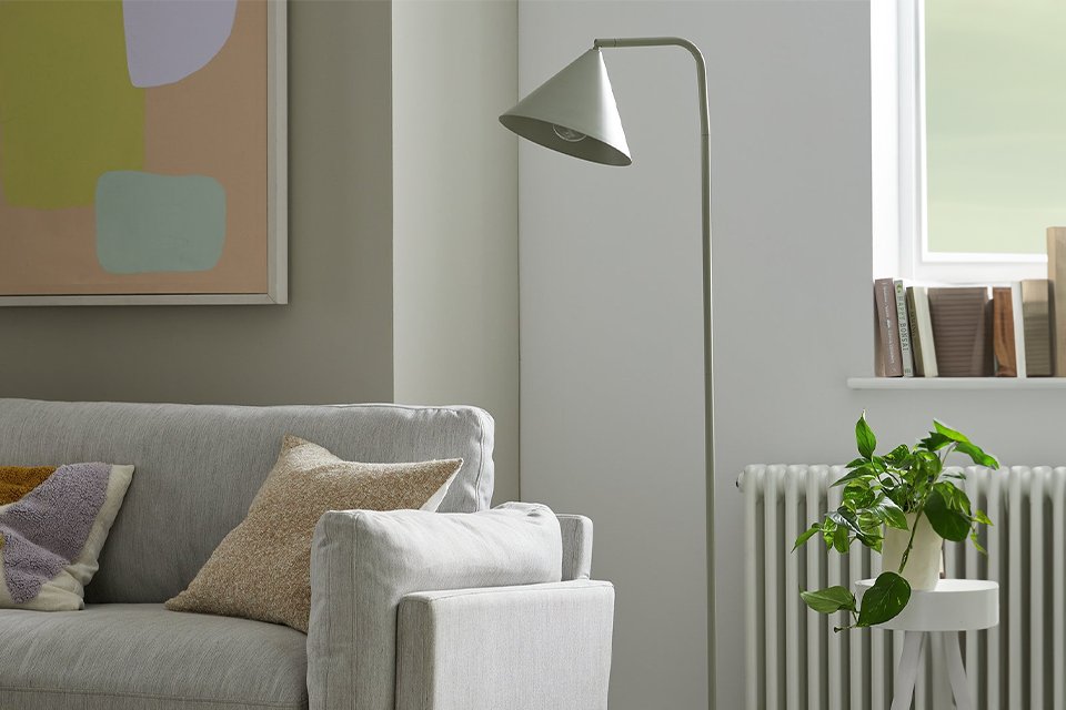 Traingle white floor lamp in living room.