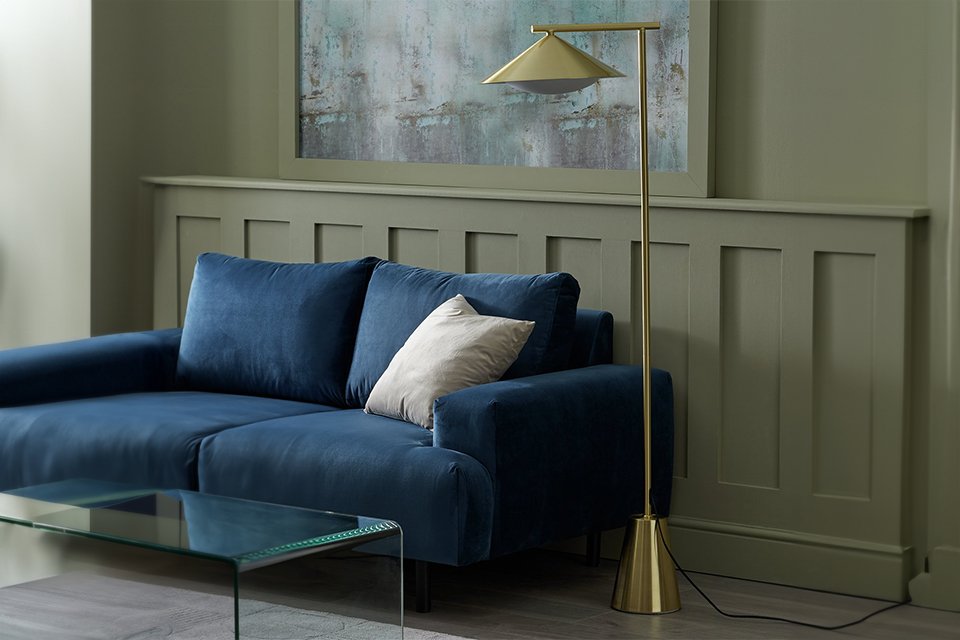 Living room with gold floor lamp.