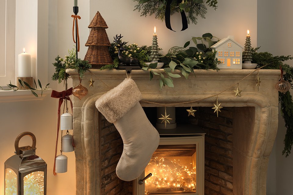 A beige stocking filler hanging over a fireplace.
