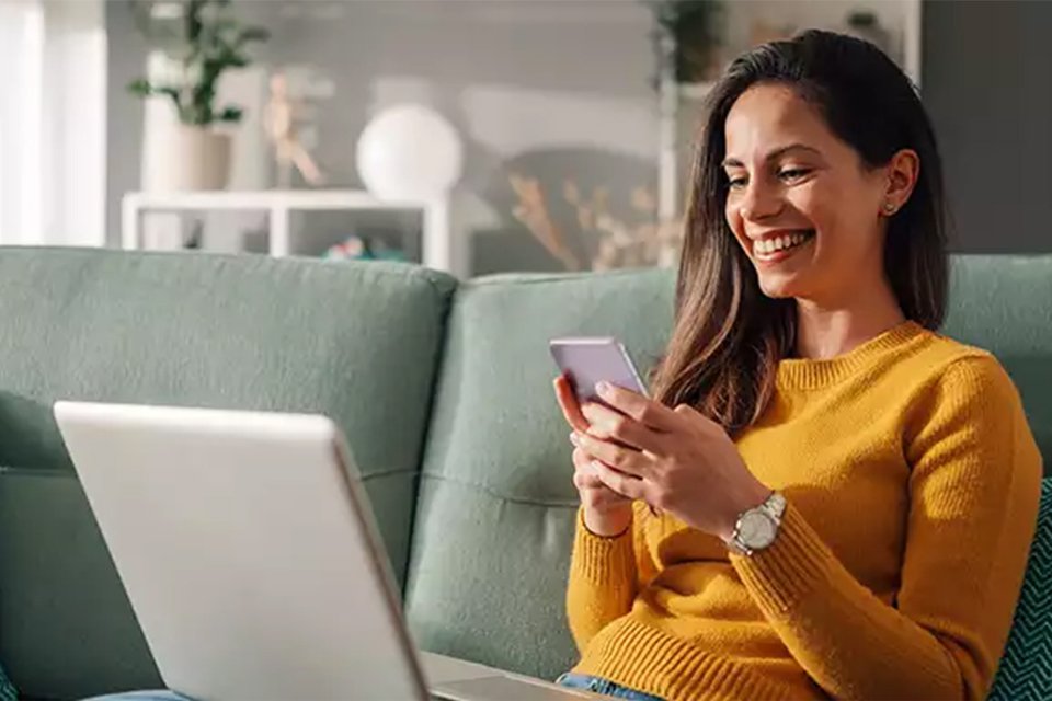  A woman exploring flexible credit options to pay with on her phone. 