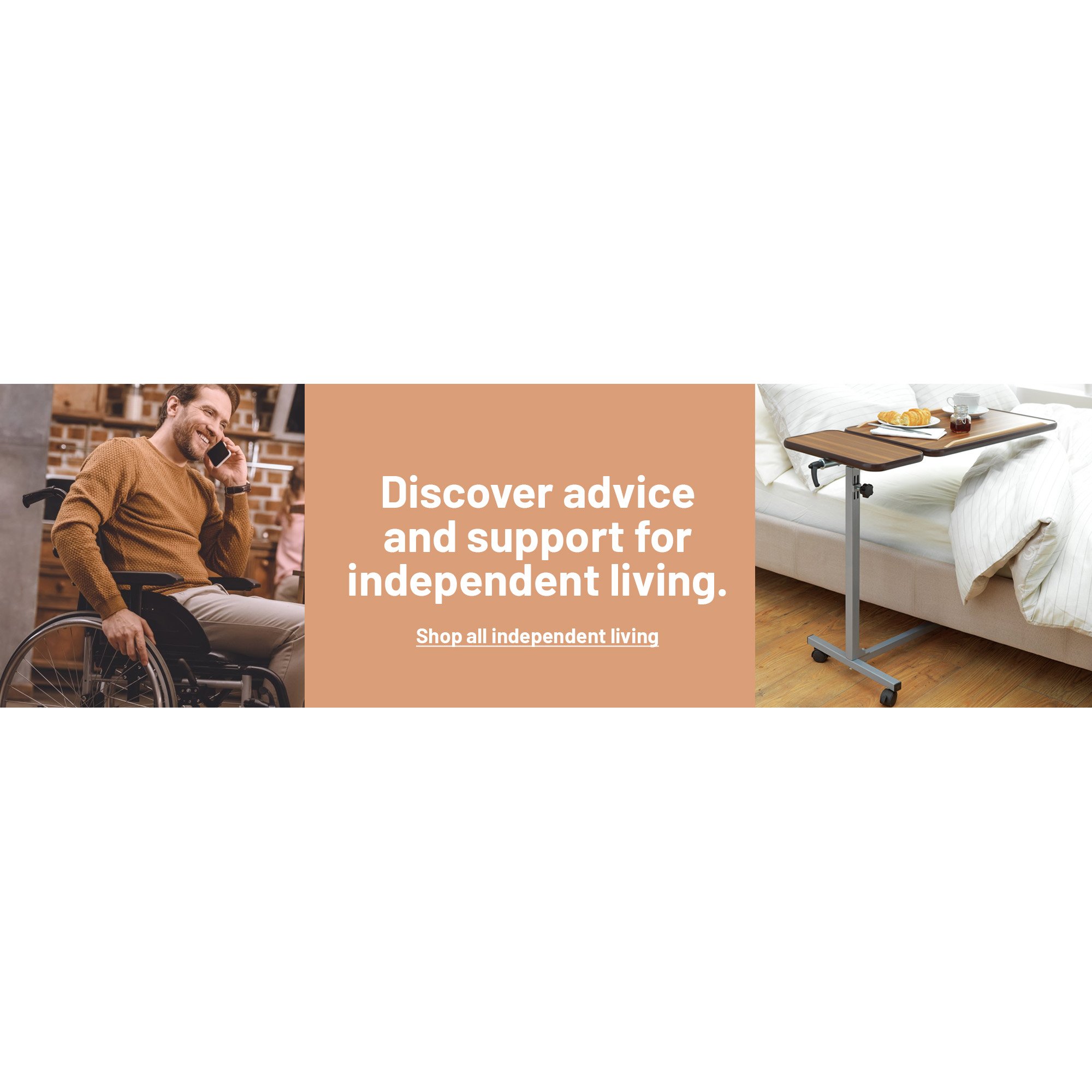 A man in a wheelchair using his phone and a laptop inside a cafe.