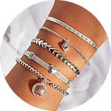 A woman wearing simply silver sterling silver 925 heart stretch bracelets.