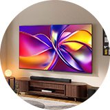 A jumbo wall-mounted smart TV in a living room setup.