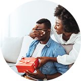 A woman surprising her partner with a gift.