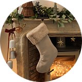 A beige stocking filler hanging over a fireplace.