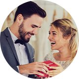 A bride and groom opening a gift box together.