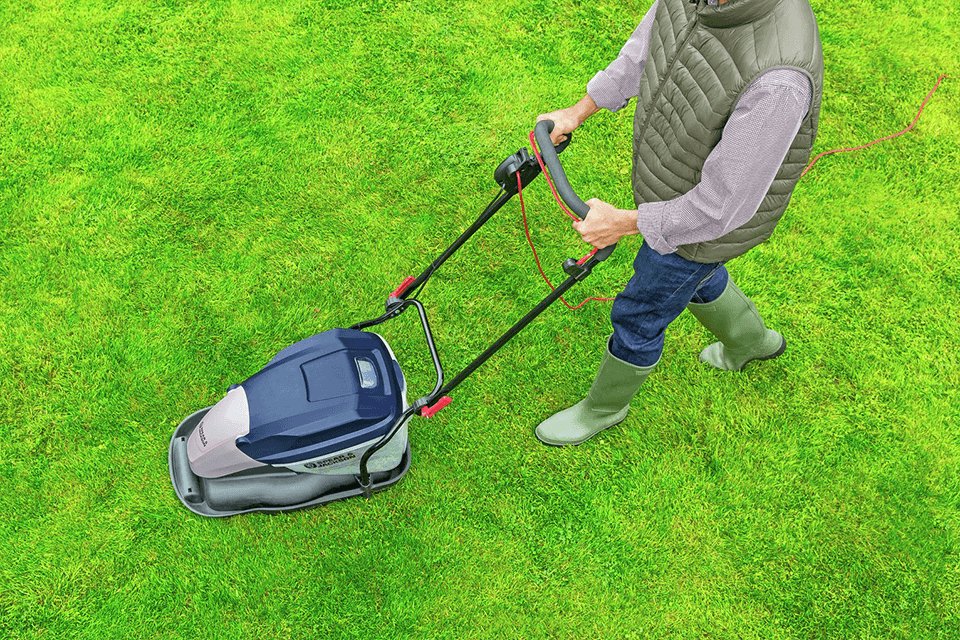  A person using Spear & Jackson 33cm Corded Hover Lawnmower.